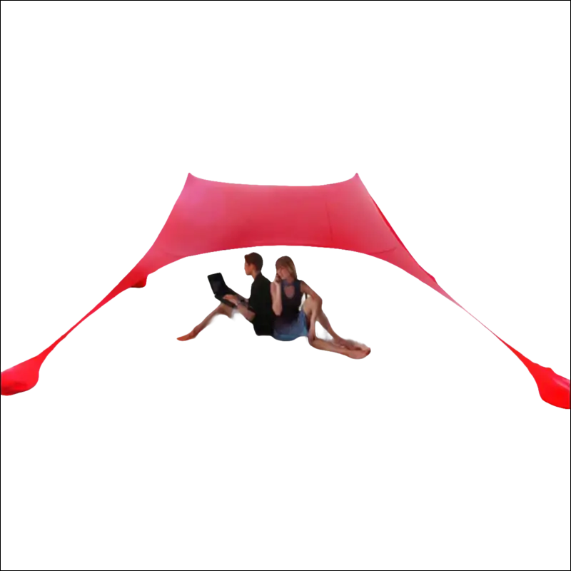 Red beach canopy sheltering two people on sand.