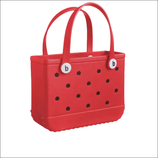 Red handbag with black polka dots and dual handles.